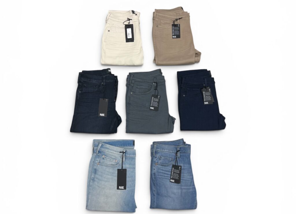 Various pairs of jeans stacked neatly,