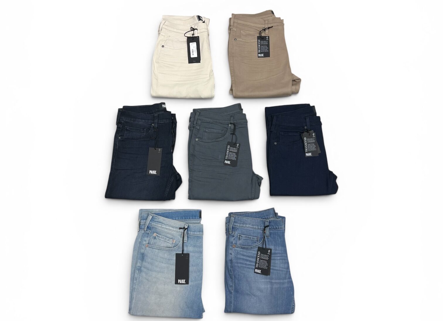 Various pairs of jeans stacked neatly,