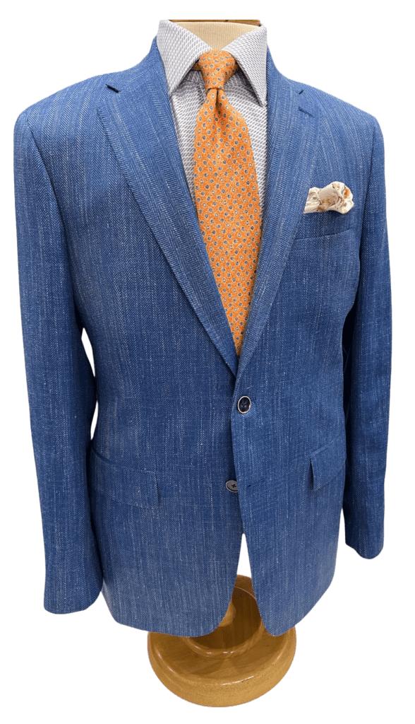 Stylish blue herringbone blazer displayed on a mannequin, paired with a patterned shirt,