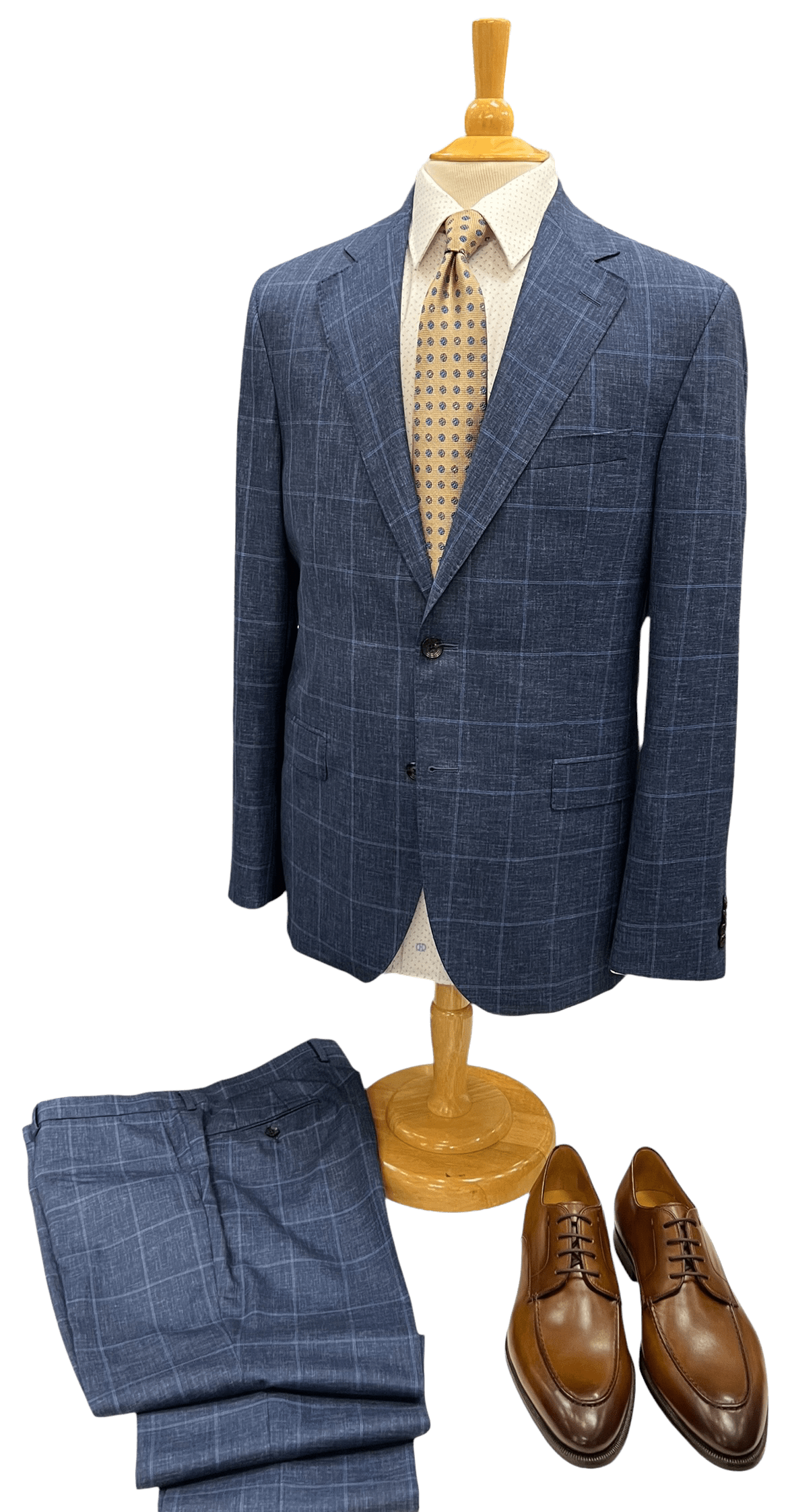 Tailored blue suit on a mannequin, paired with a light patterned shirt,
